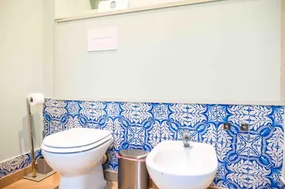 a bathroom with a toilet and a sink at Mazzini Suites Palermo in Palermo