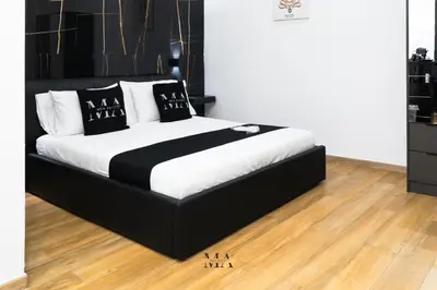 a black and white bed in a room at MEA Suite in Palermo