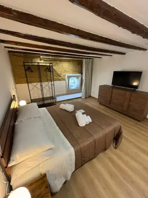 a bedroom with a large bed with two towels at Sammartino Apartment in Palermo