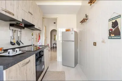 a kitchen with a refrigerator and a counter top at Dolce Sicily a 1km dal centro in Palermo