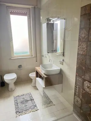 a bathroom with a sink and a toilet and a window at Dolce Sicily a 1km dal centro in Palermo