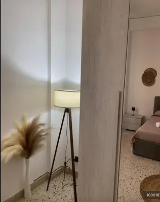 a room with a bed and a table with a lamp at Dolce Sicily a 1km dal centro in Palermo