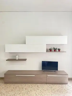 a living room with a table with a tv on it at Dolce Sicily a 1km dal centro in Palermo