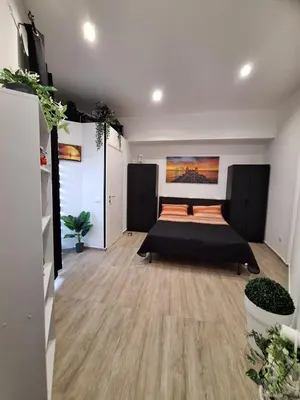 a bedroom with a bed in the middle of a room at Tukory Central room Palermo in Palermo