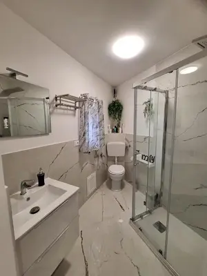 a bathroom with a toilet and a sink and a shower at Tukory Central room Palermo in Palermo
