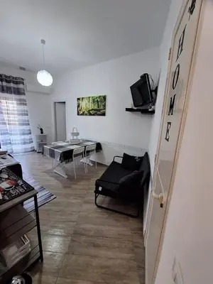 a living room with a couch and a table at Tukory Central room Palermo in Palermo