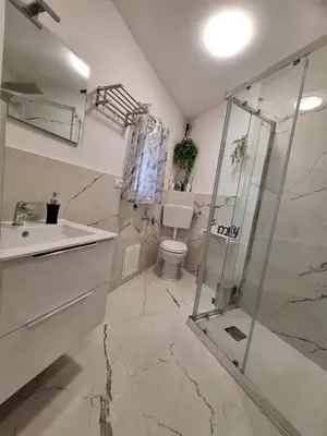 a bathroom with a shower and a toilet and a sink at Tukory Central room Palermo in Palermo