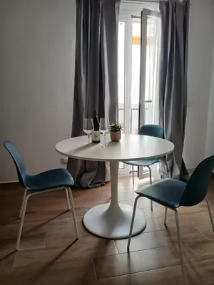a white table and chairs in a room at Esse & Emme in Palermo