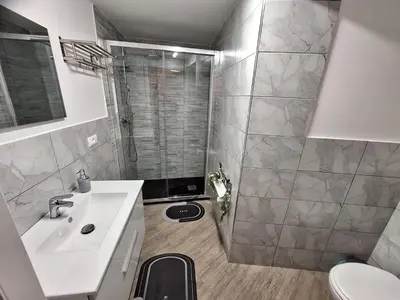 a bathroom with a shower and a sink and a toilet at Normanni Deluxe Room Palermo in Palermo