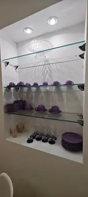 a shelf with purple plates and glasses on it at Leoni di Sicilia in Palermo