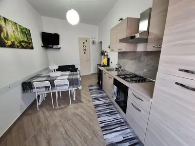 a kitchen with a table with chairs and a stove at Cattedrale Superior Room plus Terrace Palermo in Palermo