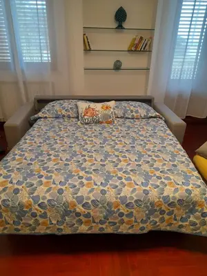 a bedroom with a bed with a colorful comforter at Villa Yasmine in Cinisi