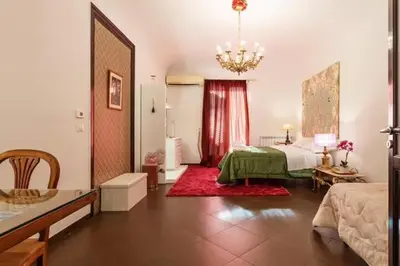 a bedroom with a bed and a chandelier at Casa Lulú in Palermo