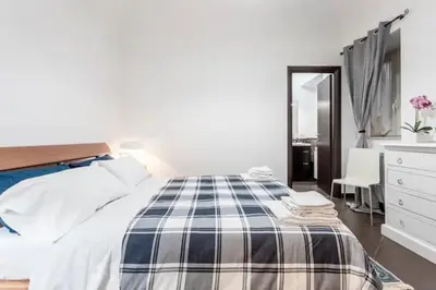 a bedroom with a bed and a dresser and a mirror at Casa Lulú in Palermo