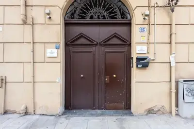 a large brown door on the side of a building at Casa Lulú in Palermo