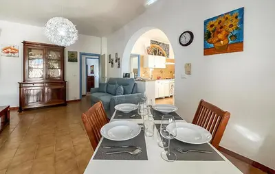 a dining room with a table with chairs and a couch at Stunning Apartment In Balestrate in Balestrate