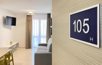 a living room with a couch and a clock on a wall at 1 Bedroom Cozy Apartment In Balestrate in Balestrate