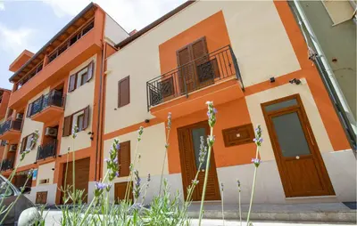 a building with orange and white at 1 Bedroom Cozy Apartment In Balestrate in Balestrate