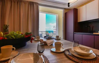a dining room table with a view of the ocean at 5 Bedroom Stunning Apartment In Trappeto in Trappeto