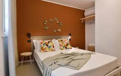 a bedroom with a bed with orange walls at 5 Bedroom Stunning Apartment In Trappeto in Trappeto