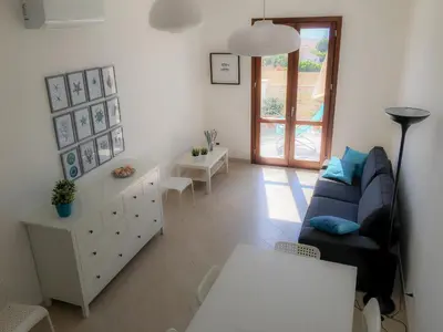 a living room with a couch and a table at Casa Turchese Unmarediblu in San Vito lo Capo