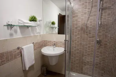 a small bathroom with a sink and a shower at Casa Turchese Unmarediblu in San Vito lo Capo