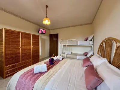 a bedroom with two beds and a bunk bed at Aspra Mare House in Ficarazzi