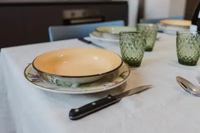 a table with two plates and a knife on it at Villa con Piscina in Balestrate