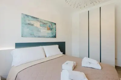 a bedroom with a bed with two towels on it at Villa con Piscina in Balestrate