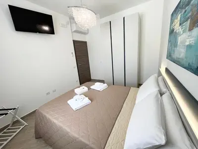 a bedroom with a bed with two towels on it at Villa con Piscina in Balestrate