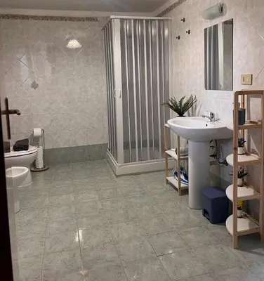 a bathroom with a sink and a shower and a toilet at Casa Mortillaro - The Heart of Palermo, Ballaro Market in Palermo