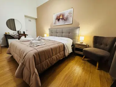 a hotel room with a bed and a chair at Pindemonte Pomelia in Palermo