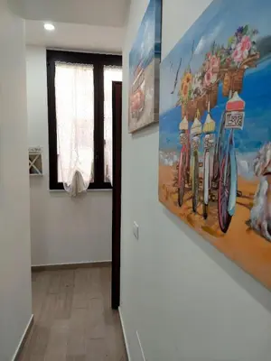 a hallway with paintings on the walls of a room at Sweet dreams AF in Palermo