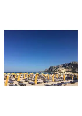 a large swimming pool with a mountain in the background at Mondello 50 Ashur in Palermo