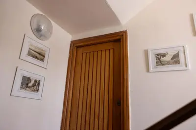 a hallway with a door and a clock on the wall at beach front bliss mondello in Palermo