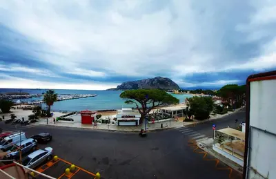 a view of a beach and a body of water at beach front bliss mondello in Palermo