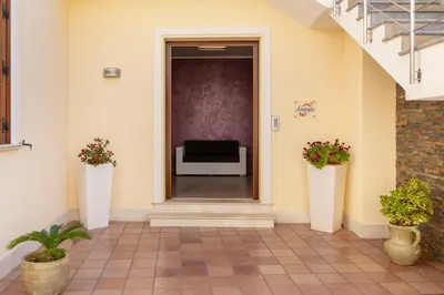 a hallway of a building with a couch in the distance at Bed&Breakfast Acasamia in Castelluzzo