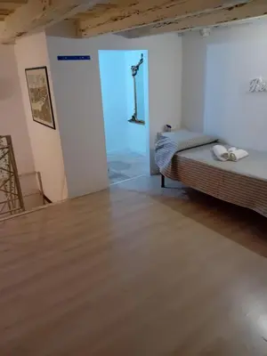 a bedroom with a bed and a wooden floor at Capo in Palermo
