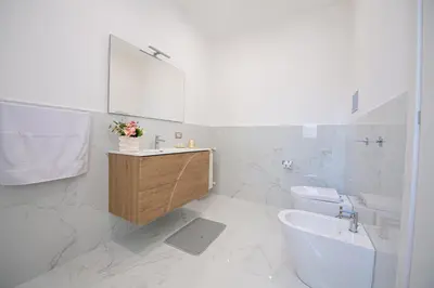 a white bathroom with a sink and a toilet at From Flori in Terrasini