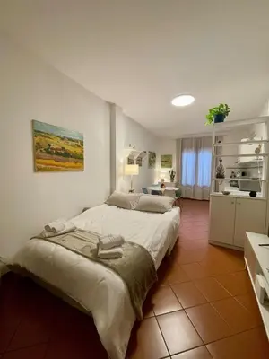 a bedroom with two beds and a kitchen at CasaPA-Appartamento a due passi dal Teatro Massimo in Palermo
