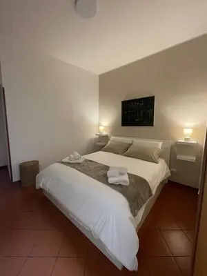 a bedroom with a large bed with two towels on it at CasaPA-Appartamento a due passi dal Teatro Massimo in Palermo