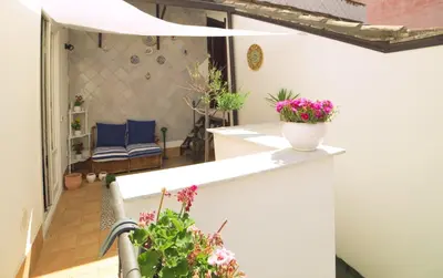 a balcony with flowers and plants on a building at Adenzia Suite in Palermo