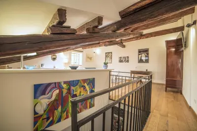 a staircase in a house with a painting on the wall at Adenzia Suite in Palermo