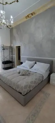 a bedroom with a large bed in a room at Casa Vacanza Marion in Palermo