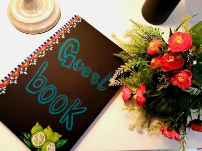 a book next to a bouquet of flowers on a table at Quattro Canti Valù in Palermo