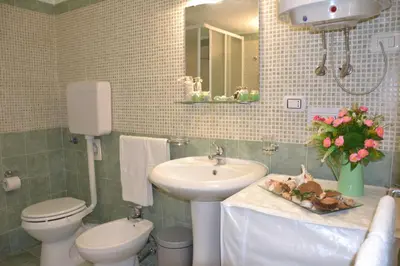 a bathroom with a sink and a toilet and a sink at Quattro Canti Valù in Palermo