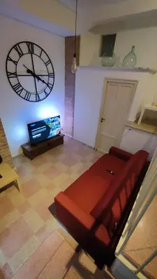 a living room with a large clock on the wall at Dimora Alla Magione in Palermo