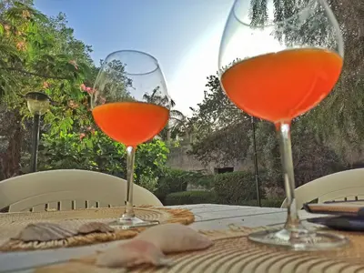 two wine glasses sitting on top of a table at Holiday Home Green Paradise in Palermo