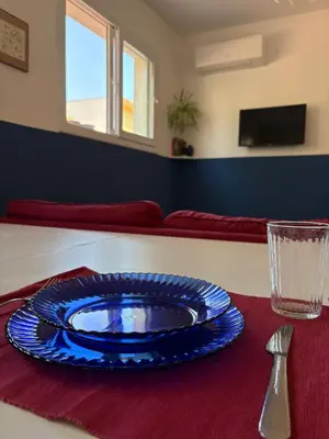 a blue plate sitting on top of a table at Nest - Family House in Santa Flavia