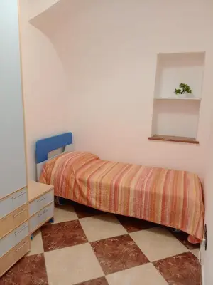 a bedroom with a bed and a dresser and a mirror at Franci Zisa House in Palermo